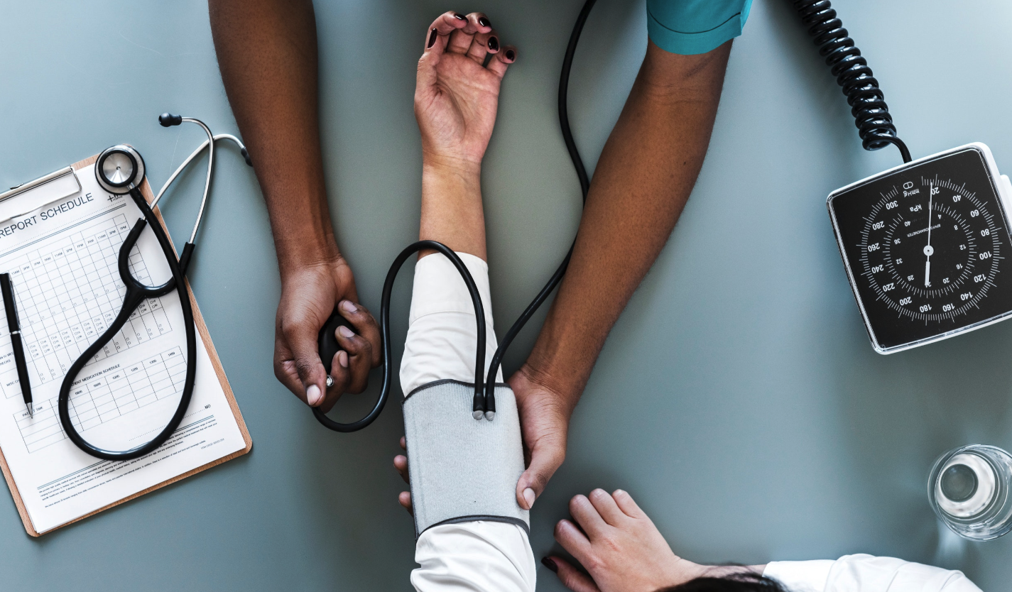 Nurse checking patients blood pressure