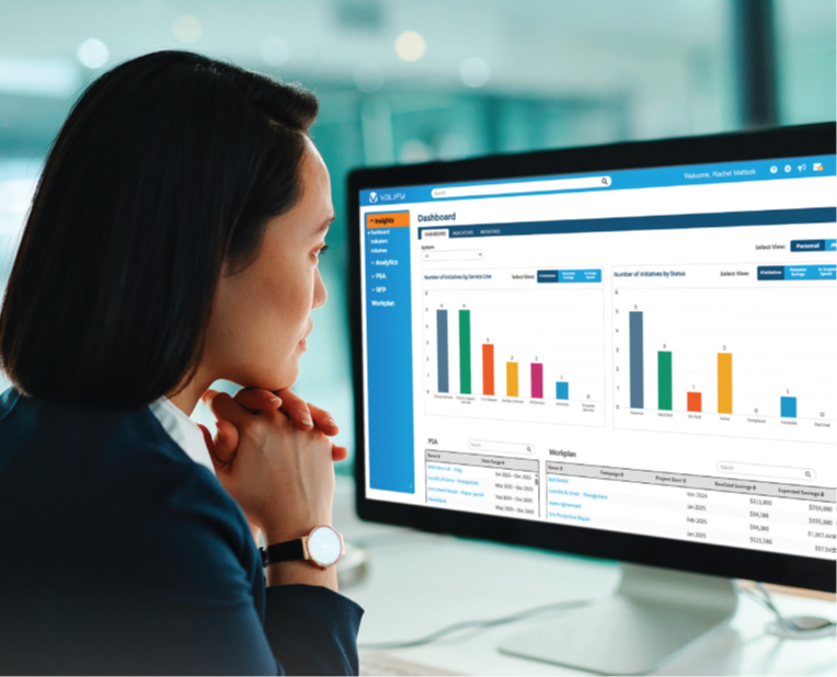 dark haired woman looking at graph on computer screen