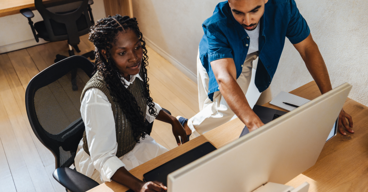 Two colleagues collaborating at a computer